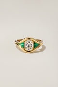 Emmy Ring, a 1.27 carat old mine cut diamond with trillion cut emerald side stones in 18k yellow gold