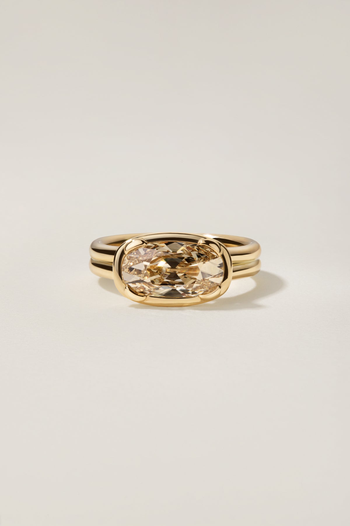 Margherita East-West, an elongated antique cut diamond set east to west in 18k yellow gold