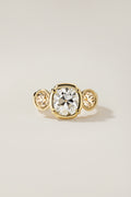 Rosa Ring, a 2.65 carat old mine cut diamond with two bezel set champagne diamond side stones