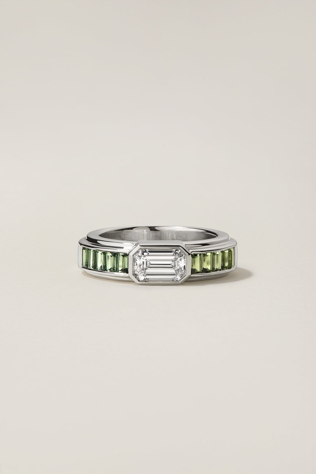 Zacca Ring, a 1.31 carat emerald cut diamond flanked by green sapphire baguettes